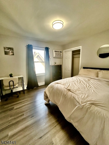 6 Charles Street, Unit 2 Montclair, NJ 07042 - Photo 2 of 13 a bedroom with a bed and wooden floor