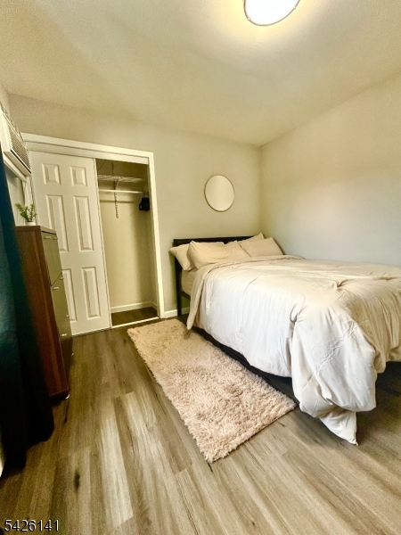 6 Charles Street, Unit 2 Montclair, NJ 07042 - Photo 3 of 13 a bedroom with a bed and a mirror