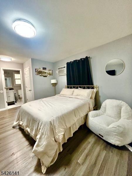 6 Charles Street, Unit 2 Montclair, NJ 07042 - Photo 5 of 13 a bedroom with double bed and a wooden floor