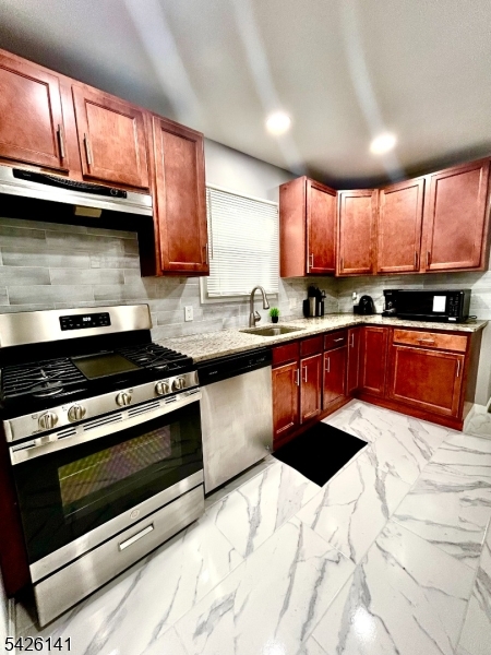 6 Charles Street, Unit 2 Montclair, NJ 07042 - Photo 6 of 13 a kitchen with stainless steel appliances granite countertop a stove a sink and a microwave