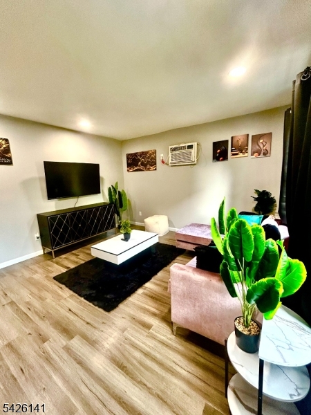 6 Charles Street, Unit 2 Montclair, NJ 07042 - Photo 10 of 13 a living room with furniture potted plant and a flat screen tv