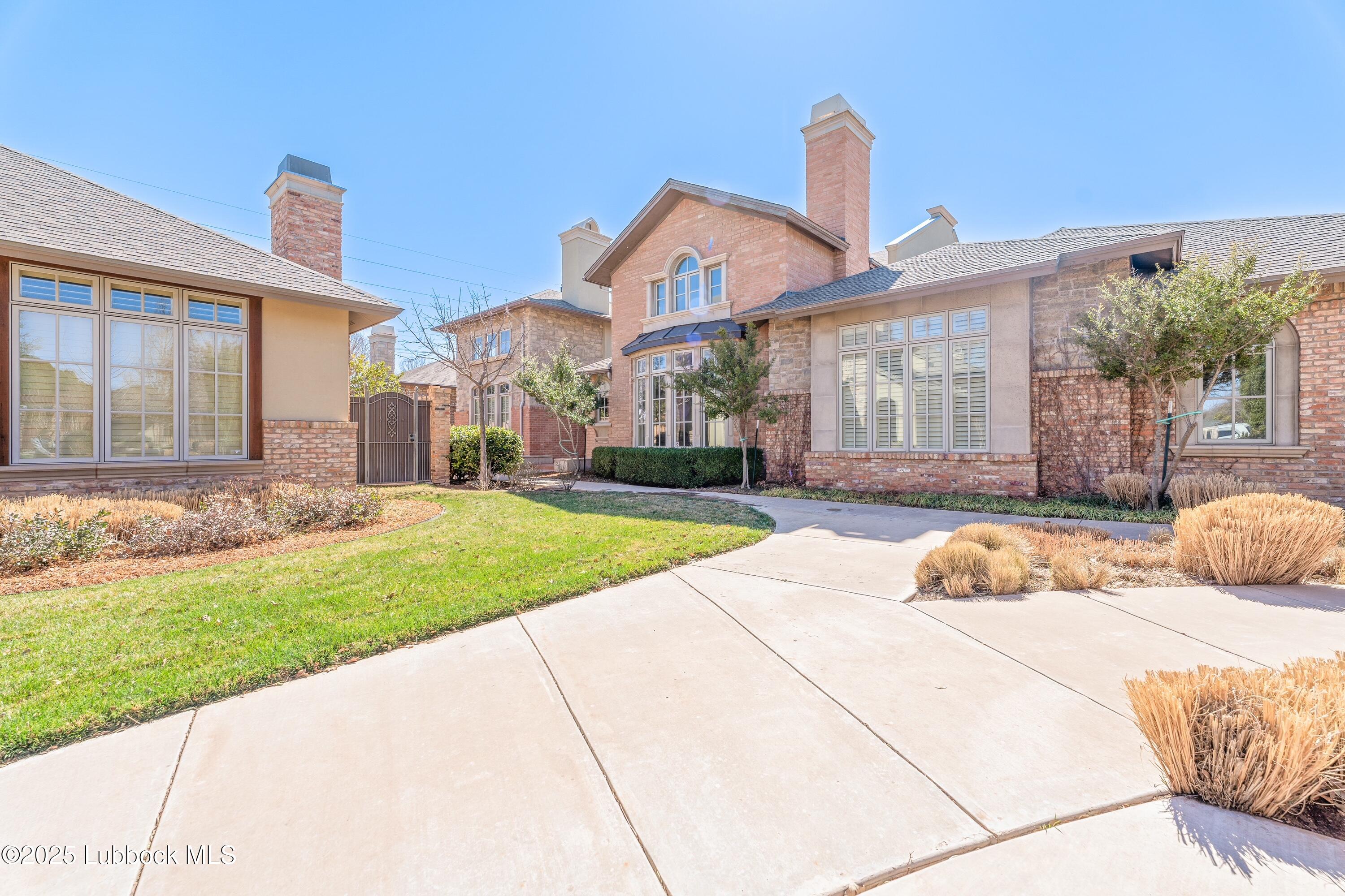 4501 19th Street, Unit 7 Lubbock, TX 79407 - Photo 1 of 30 a front view of a house with a yard