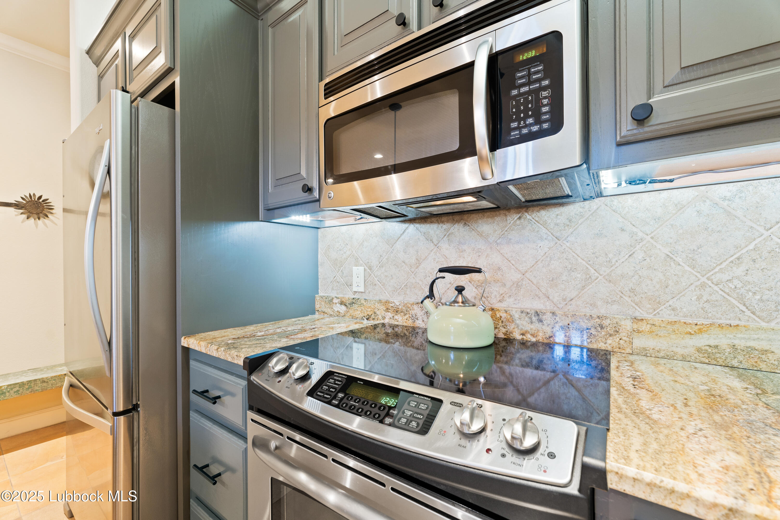 4501 19th Street, Unit 7 Lubbock, TX 79407 - Photo 12 of 30 a stove top oven sitting inside of a kitchen