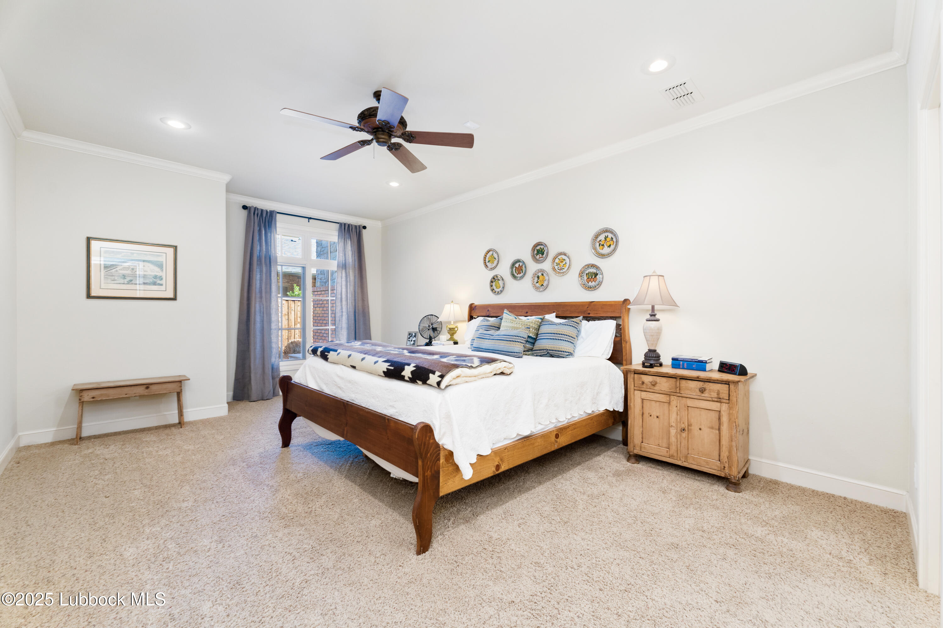 4501 19th Street, Unit 7 Lubbock, TX 79407 - Photo 13 of 30 a bed room with a bed and a lamp