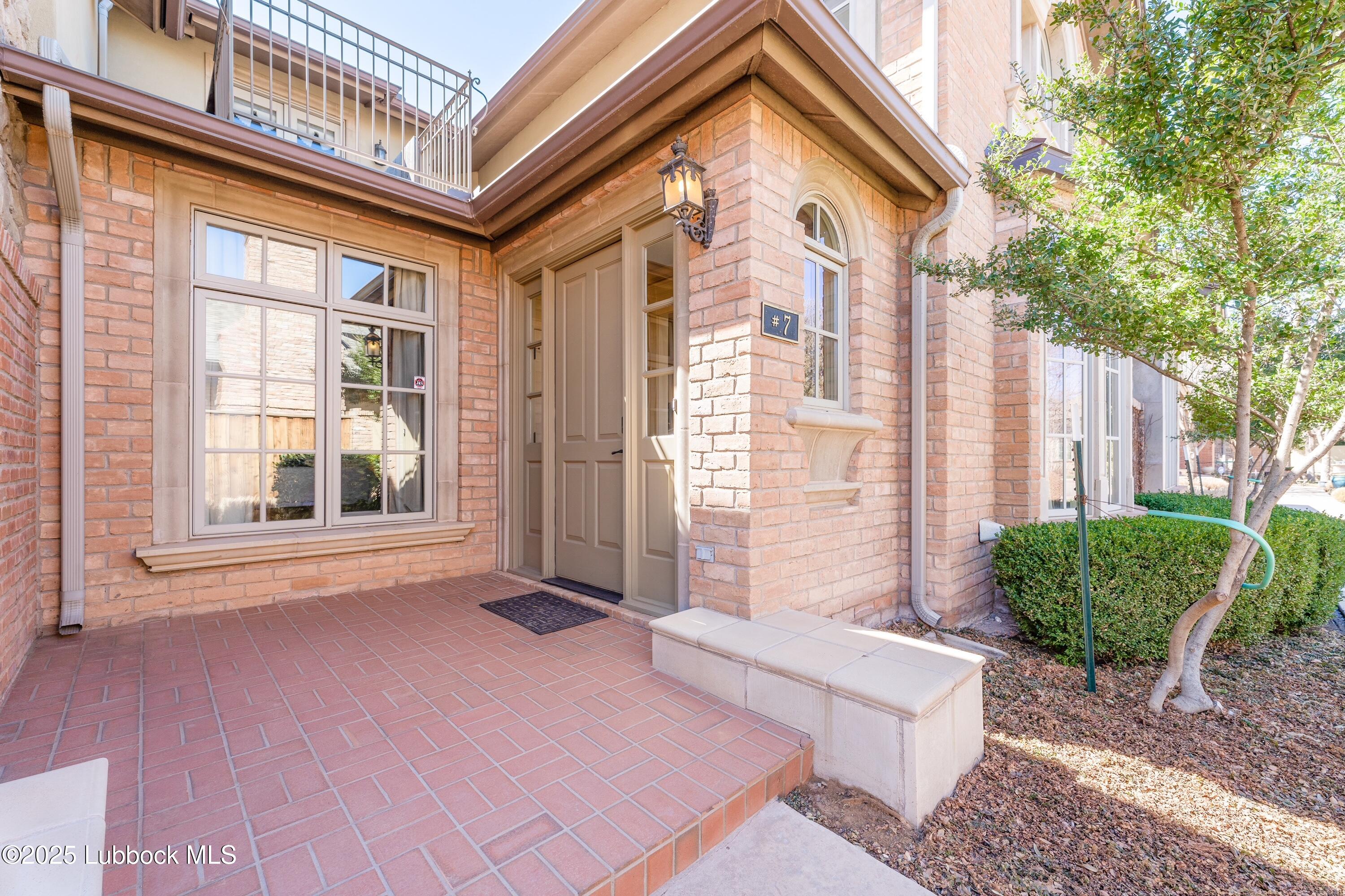 4501 19th Street, Unit 7 Lubbock, TX 79407 - Photo 2 of 30 a front view of a house with a yard