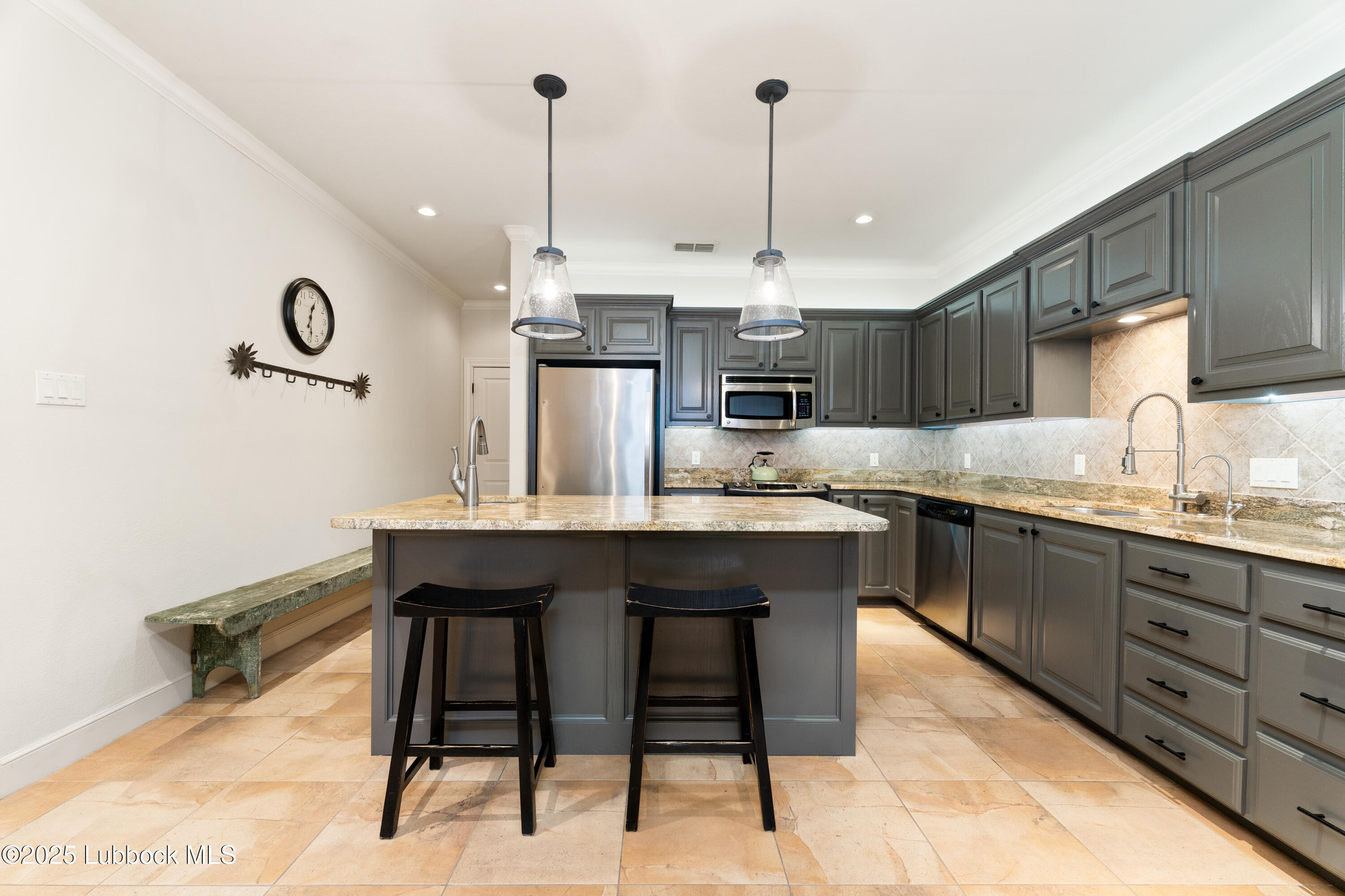 4501 19th Street, Unit 7 Lubbock, TX 79407 - Photo 10 of 30 a kitchen with kitchen island a dining table chairs sink and cabinets