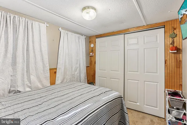 a view of a bedroom with furniture and window