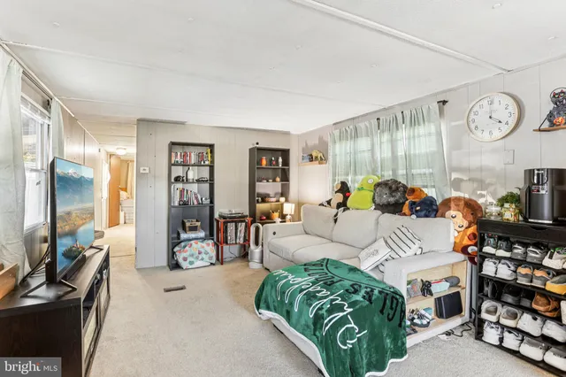 a view of a dining room with furniture and a chandelier