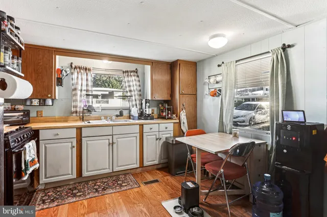 a kitchen with a refrigerator and a stove top oven