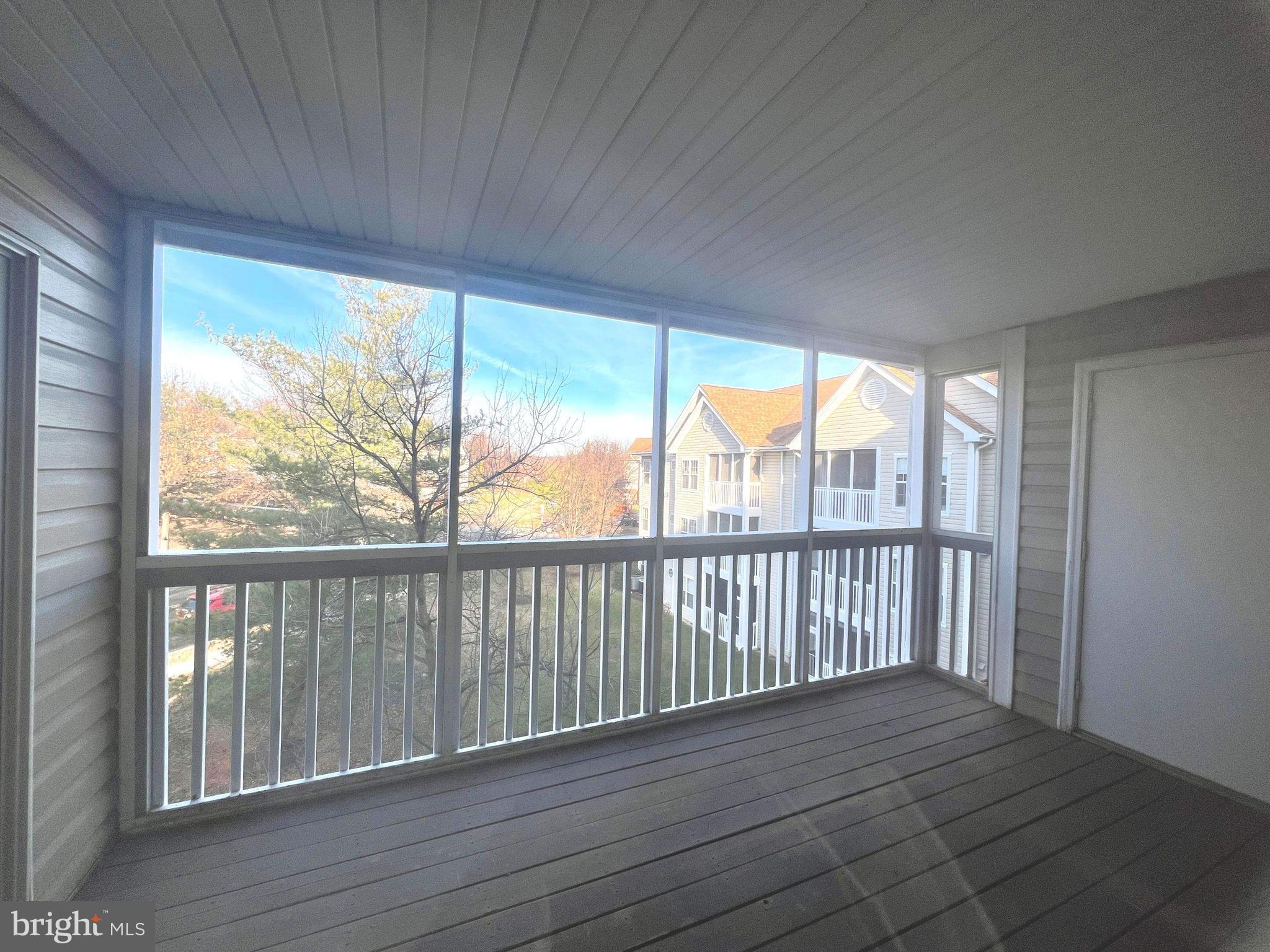 6502 Home Water Court, Unit 303 Glen Burnie, MD 21060 - Photo 4 of 14 a view of a room with wooden floor and a window