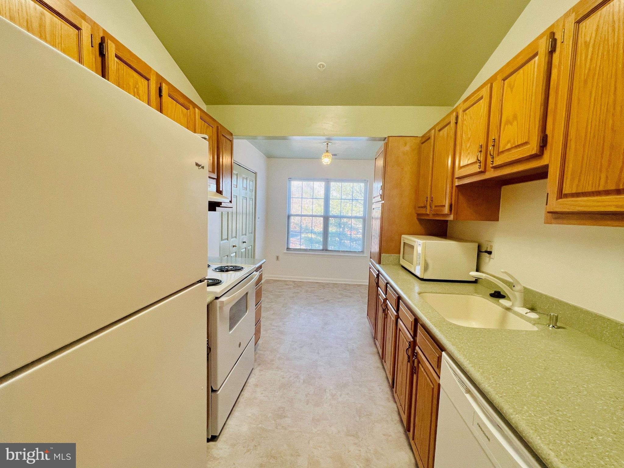 6502 Home Water Court, Unit 303 Glen Burnie, MD 21060 - Photo 6 of 14 a kitchen with a sink and wooden floor
