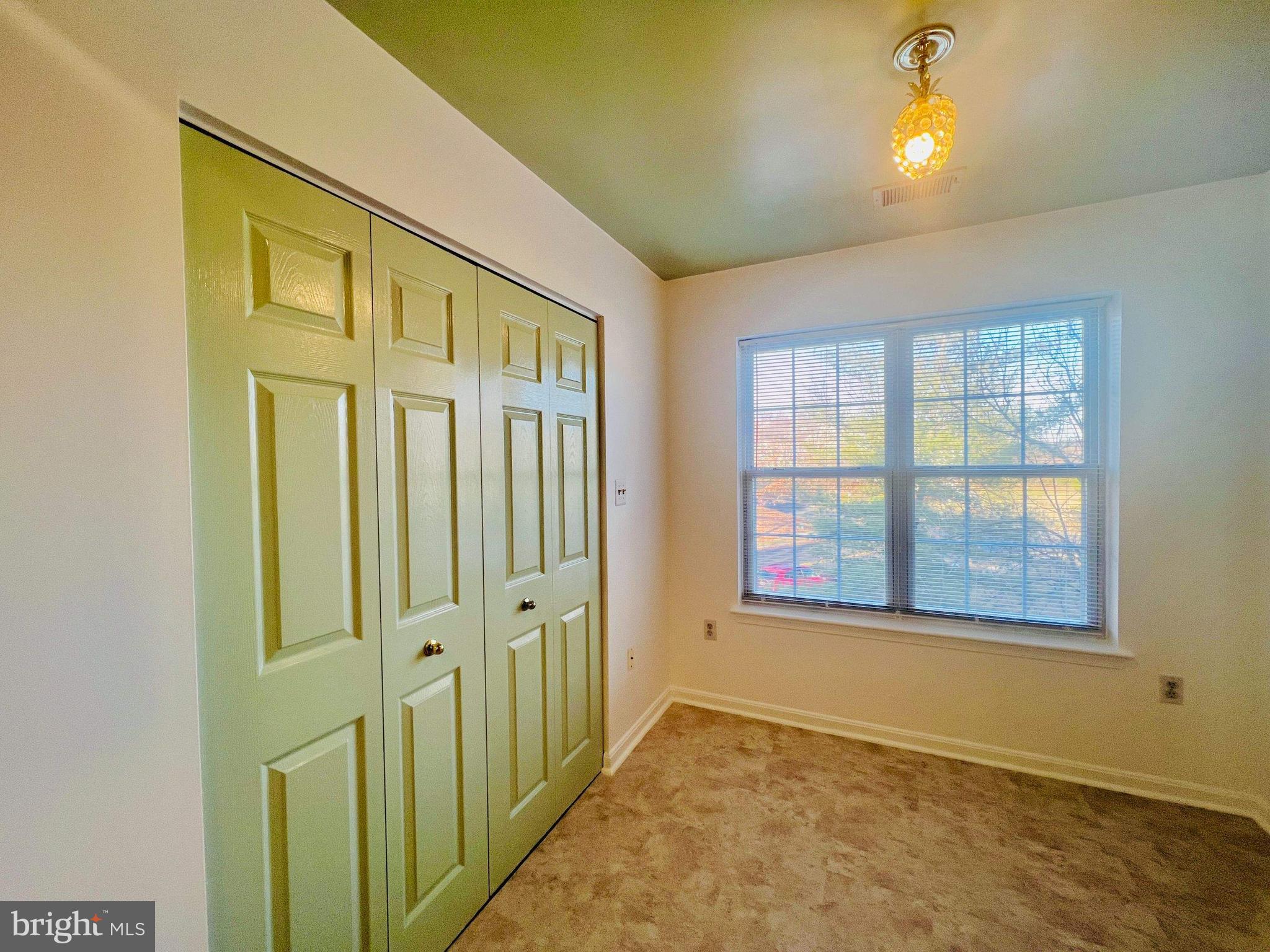 6502 Home Water Court, Unit 303 Glen Burnie, MD 21060 - Photo 7 of 14 an empty room with windows