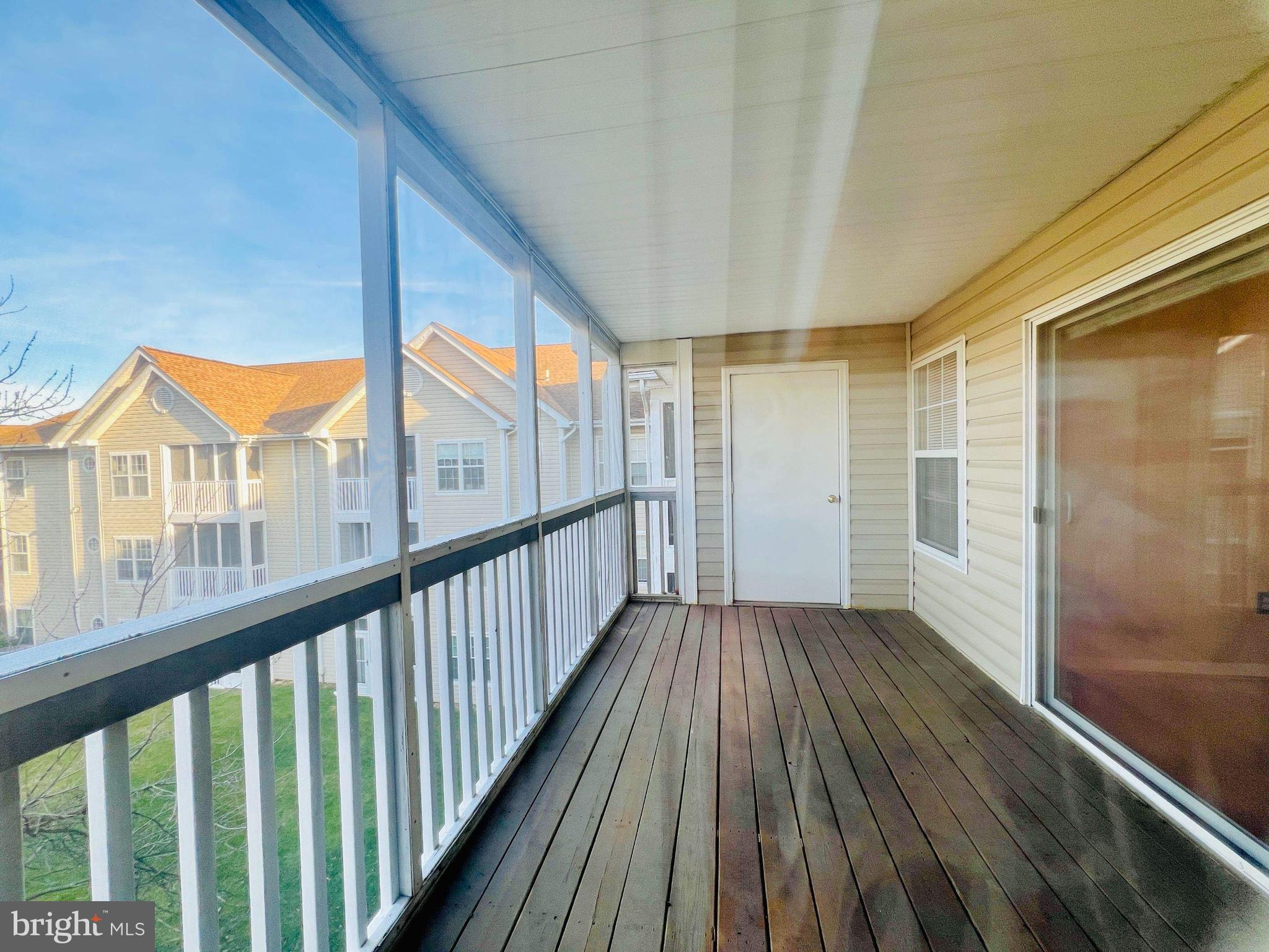 6502 Home Water Court, Unit 303 Glen Burnie, MD 21060 - Photo 9 of 14 a view of a balcony with wooden floor