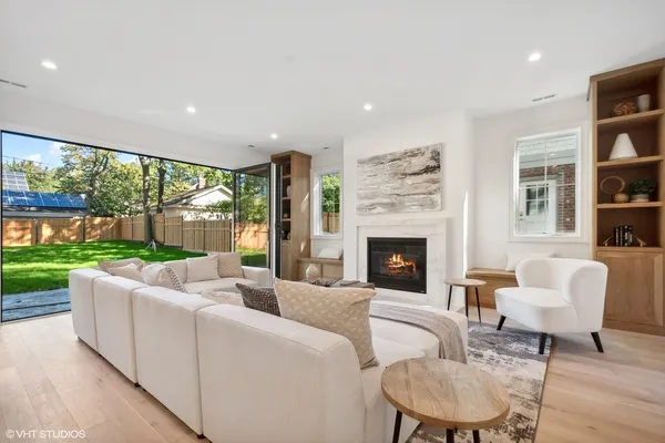 a living room with furniture fireplace and a floor to ceiling window