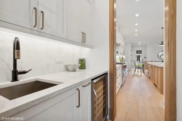 a kitchen with a sink appliances and cabinets