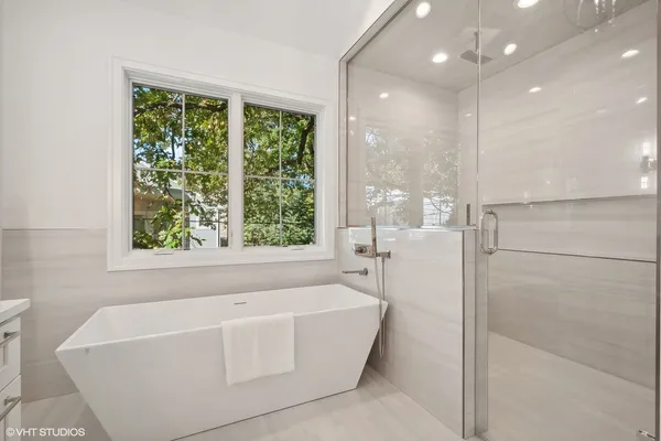 a bathroom with a bathtub and shower