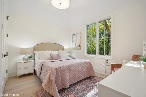 a bedroom with a bed and a large window