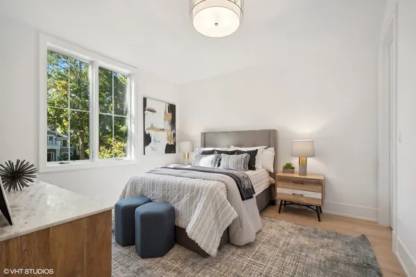 a bedroom with a bed and a large window