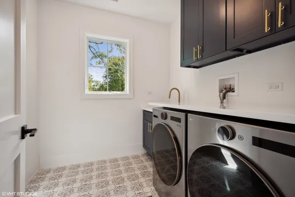 a close view of a sink a washer and dryer