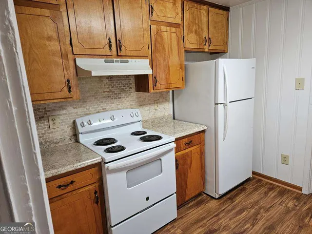 a kitchen with a stove sink and refrigerator