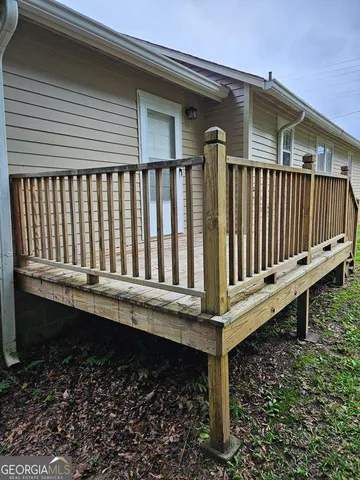 a view of a house with wooden fence