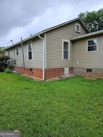 a front view of house with yard and outdoor seating