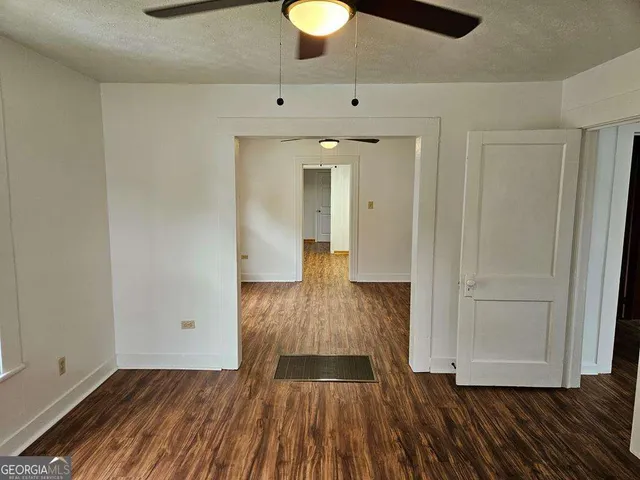 a view of a room with wooden floor and cabinet