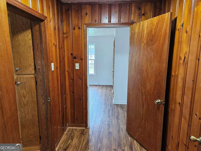 a view of walk in closet with wooden floor