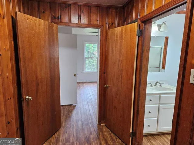 a view of walk in closet with wooden floor