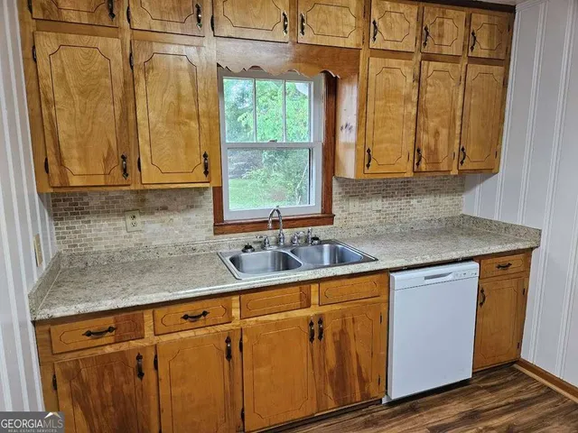 a kitchen with stainless steel appliances granite countertop a sink and a cabinets
