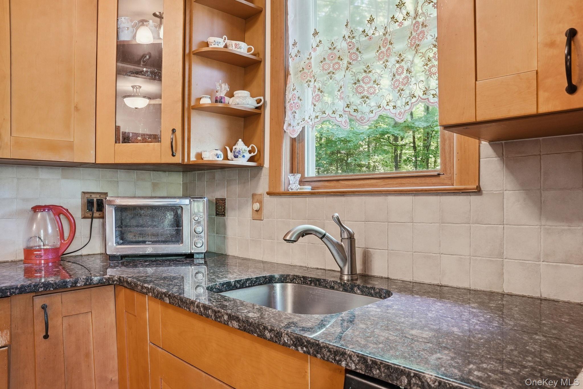 370 Starlight Road Monticello, NY 12701 - Photo 19 of 49 a kitchen with granite countertop a sink and a window