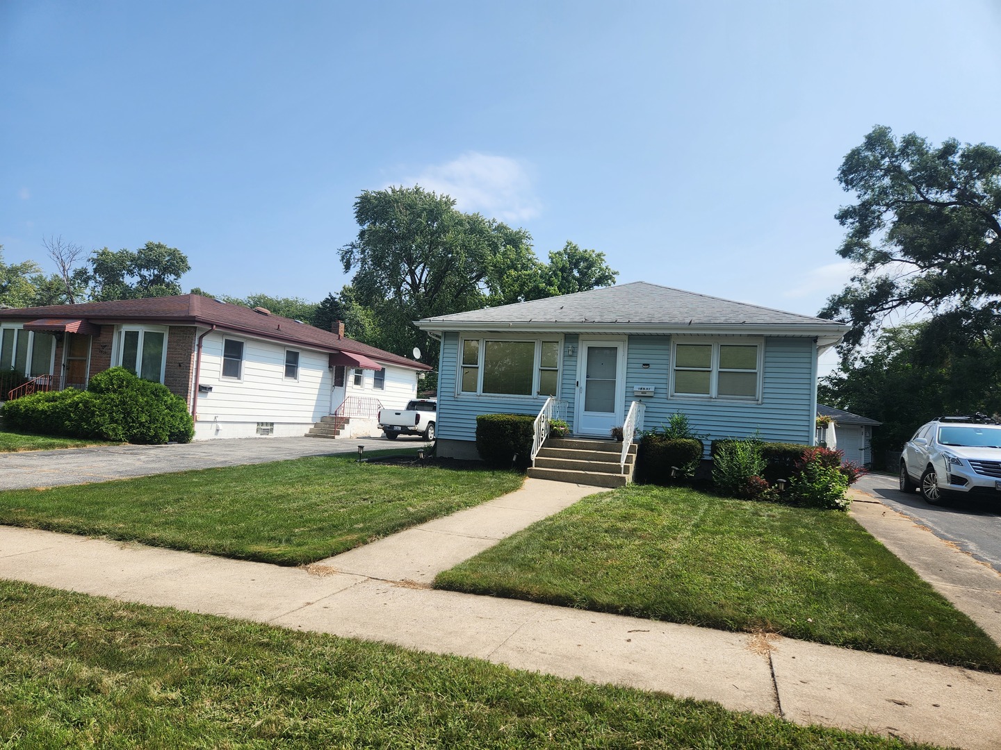 Undisclosed Address Lansing, IL 60438 - Photo 1 of 16 a front view of a house with a garden and trees