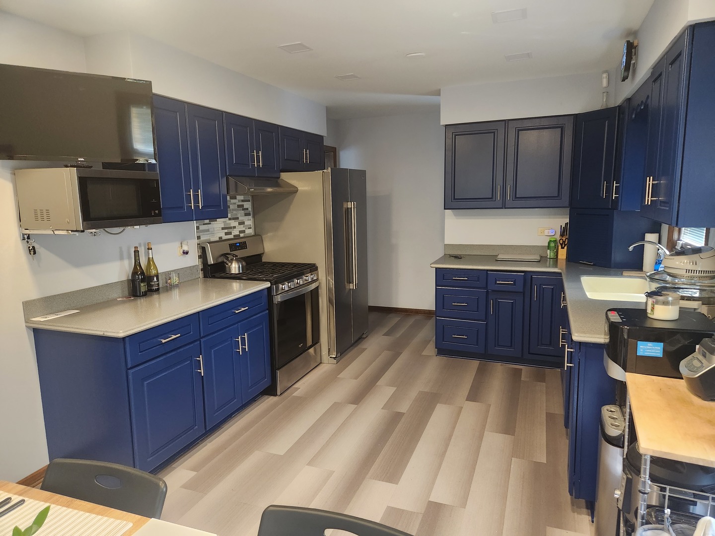 Undisclosed Address Lansing, IL 60438 - Photo 3 of 16 a kitchen with stainless steel appliances granite countertop wooden cabinets a stove top oven a sink and dishwasher