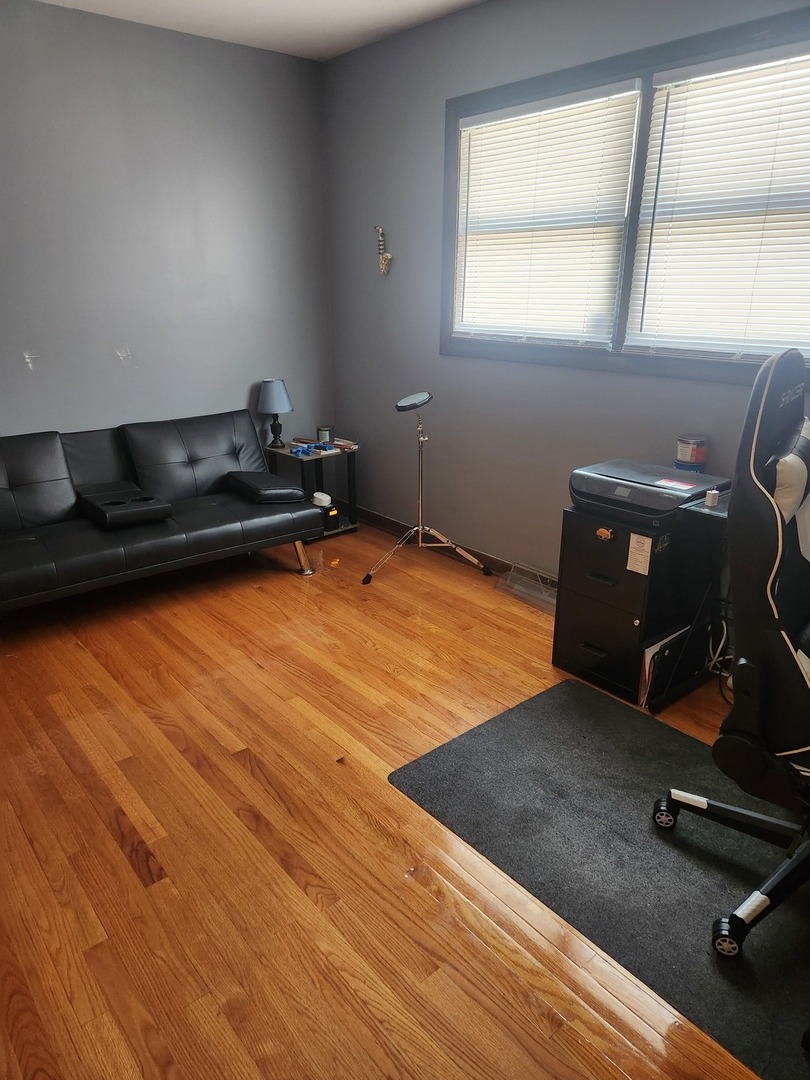 Undisclosed Address Lansing, IL 60438 - Photo 5 of 16 a room with wooden floor and furniture