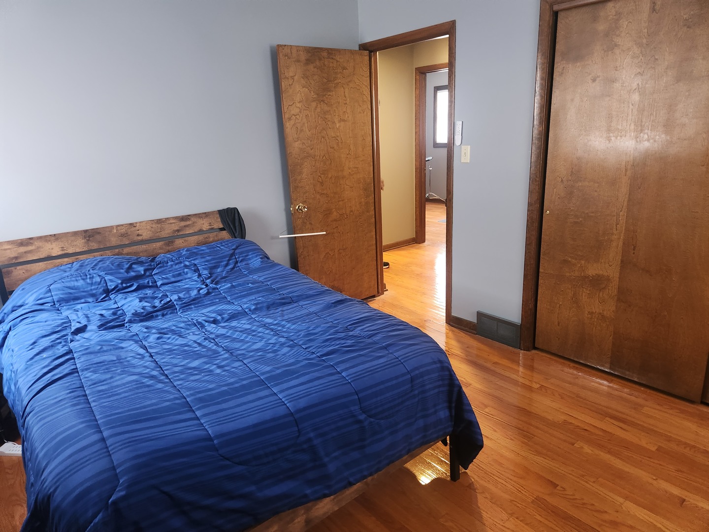 Undisclosed Address Lansing, IL 60438 - Photo 8 of 16 a bed sitting in a spacious bedroom next to a bathroom