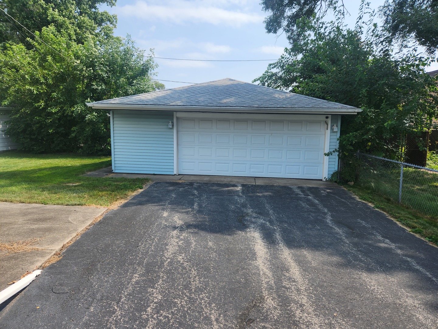 Undisclosed Address Lansing, IL 60438 - Photo 9 of 16 a front view of a house with a yard and garage