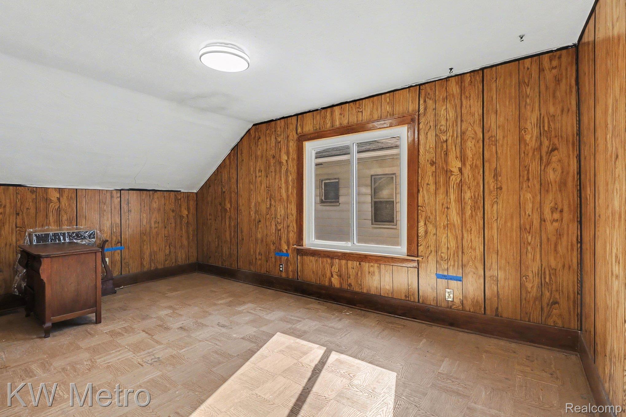 85 Walnut Street River Rouge, MI 48218 - Photo 15 of 20 Bonus room with wooden walls, vaulted ceiling, and parquet flooring