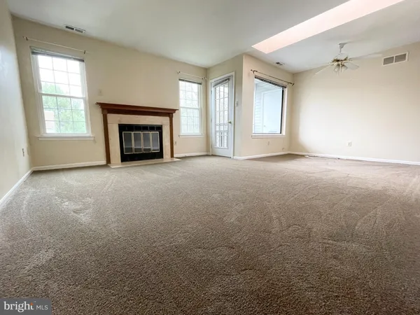 a view of empty room with a fireplace