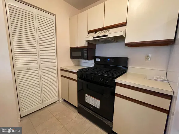 a kitchen with a stove and a white cabinet