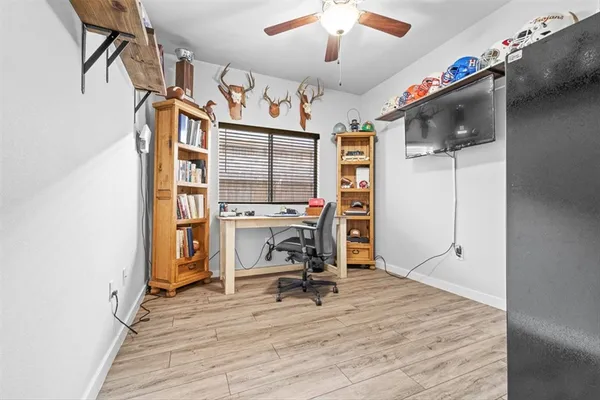 a view of a workspace with furniture and wooden floor