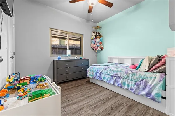 a bedroom with a bed and a dresser in it