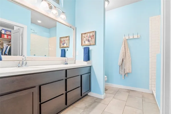 a bathroom with a double vanity sink and a mirror