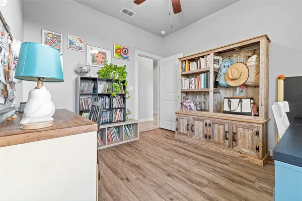 a bedroom with furniture and a book shelf