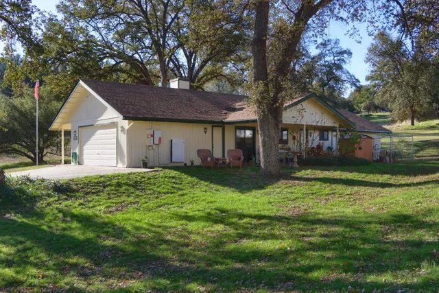 a front view of house with yard and green space