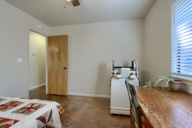 a bed room with a bed and a chair