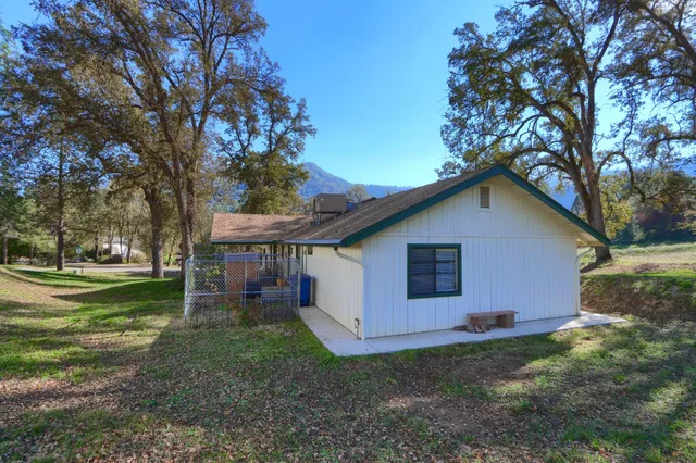 a view of a house with yard and a tree