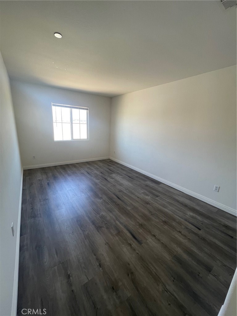 4520 Filson Street Riverside, CA 92507 - Photo 26 of 29 an empty room with wooden floor and windows