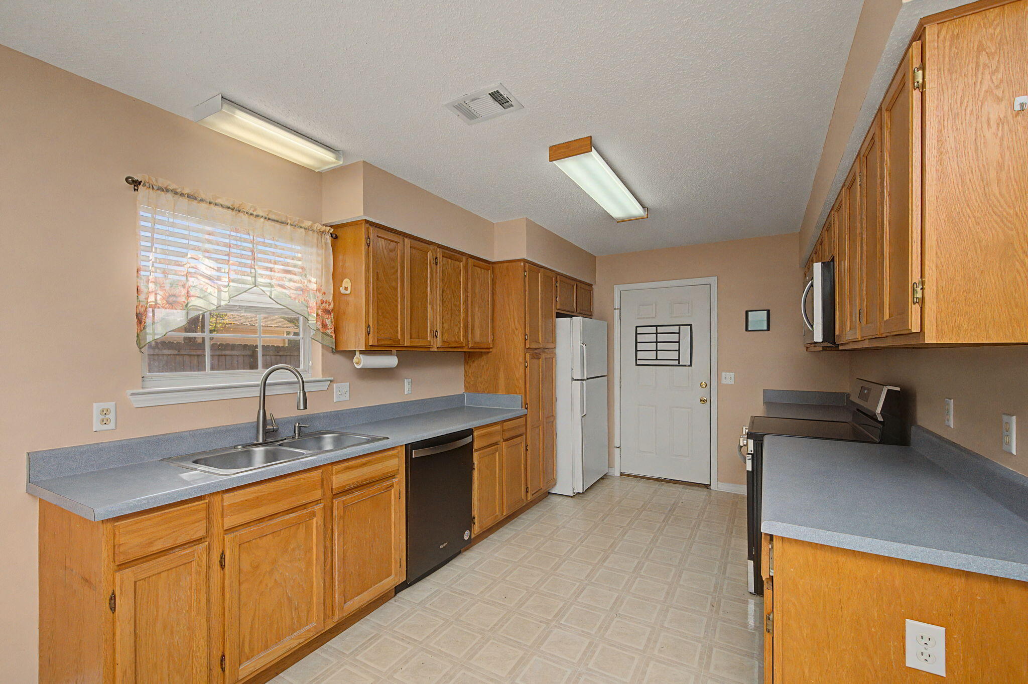 223 Runnymeade Drive Crestview, FL 32539 - Photo 11 of 38 a kitchen with stainless steel appliances granite countertop a sink stove and cabinets