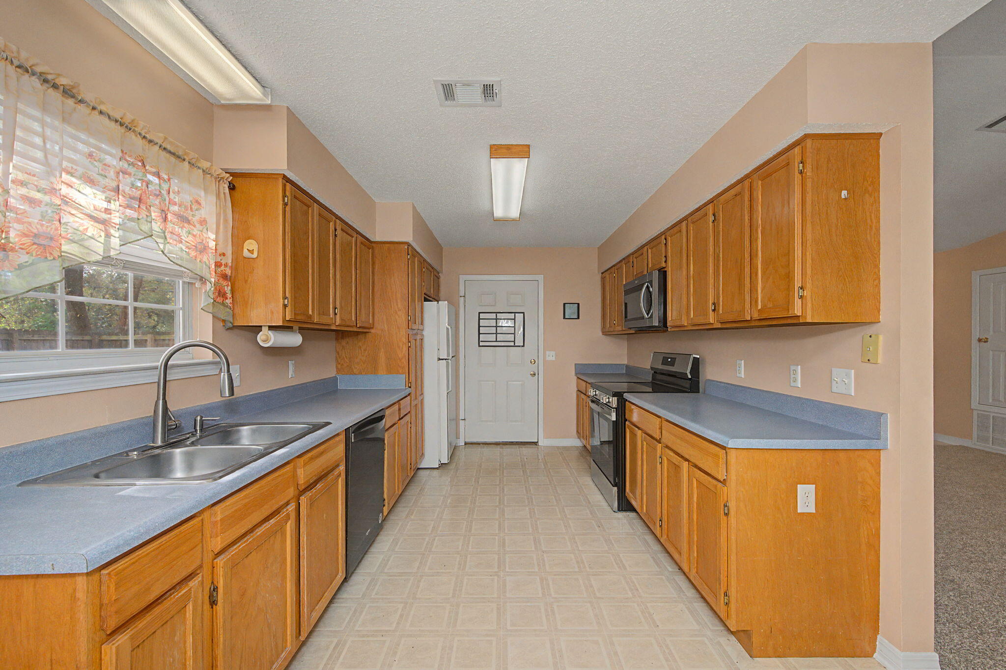 223 Runnymeade Drive Crestview, FL 32539 - Photo 12 of 38 a kitchen with stainless steel appliances granite countertop a sink stove and cabinets