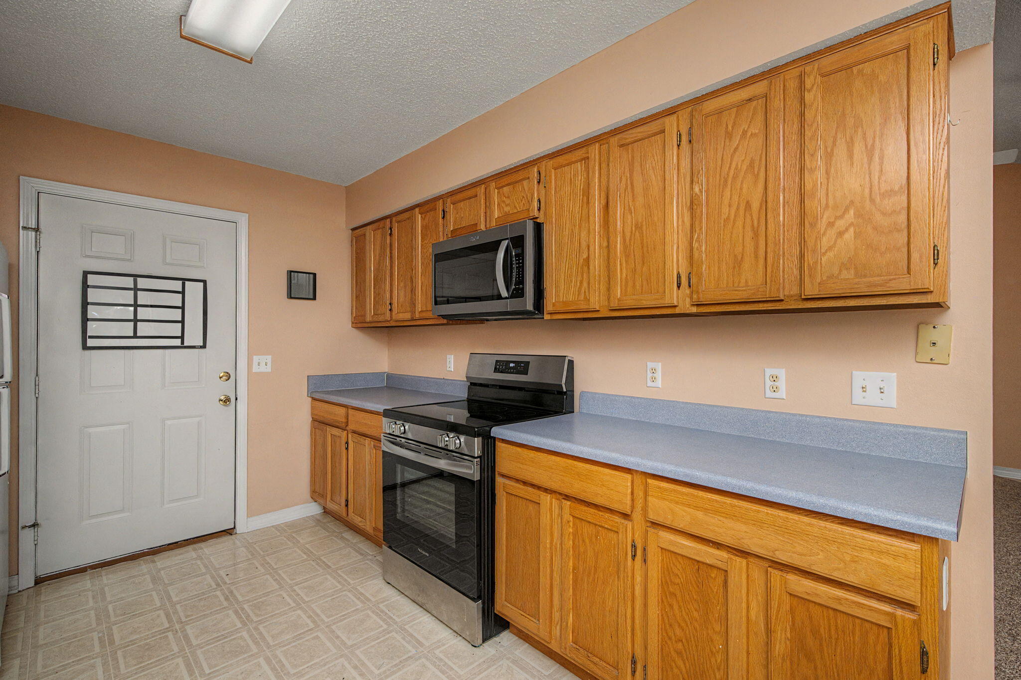 223 Runnymeade Drive Crestview, FL 32539 - Photo 14 of 38 a kitchen with stainless steel appliances granite countertop a stove a sink and a microwave